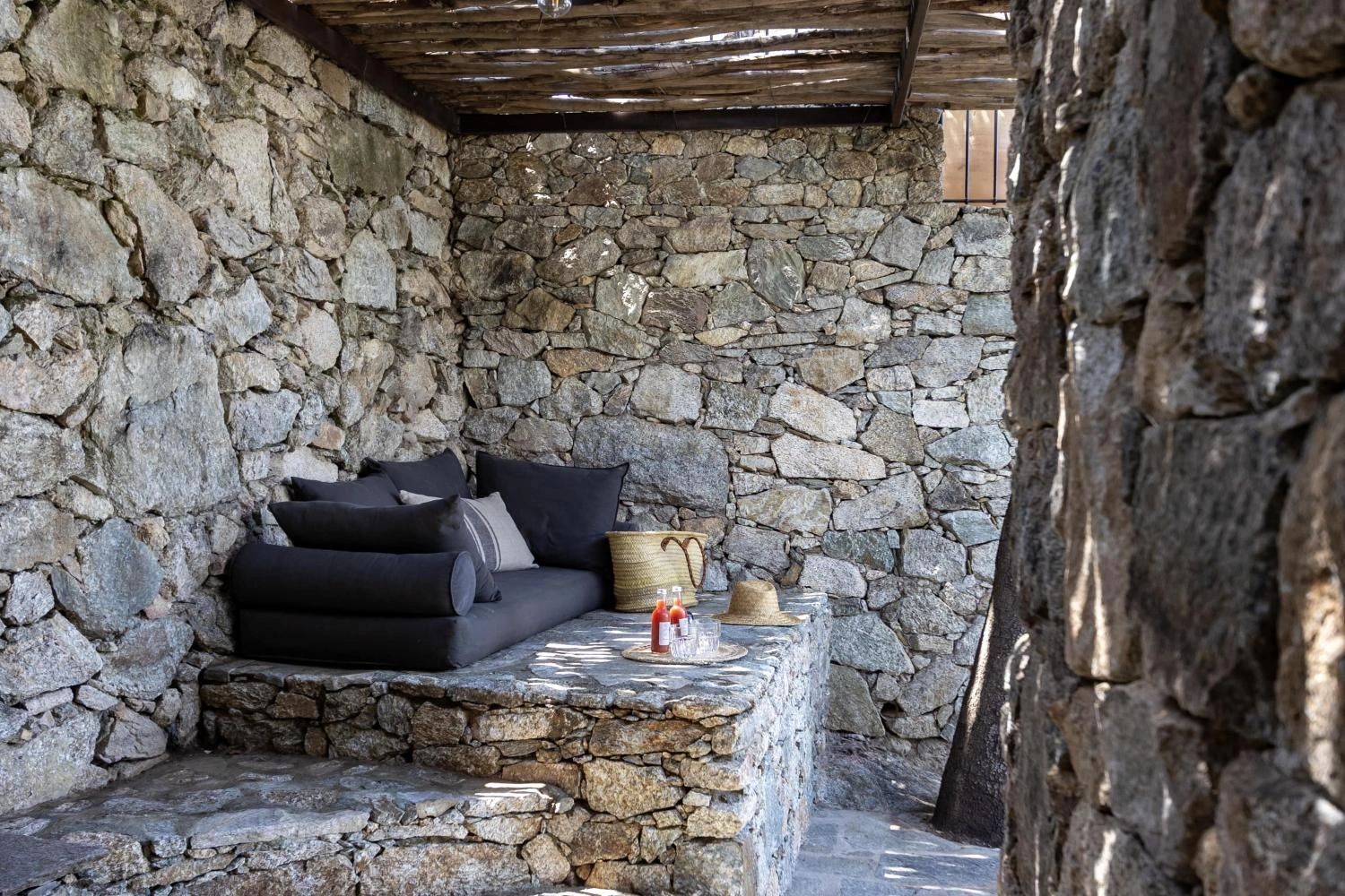 Le salon en pierre des chambres à louer de l'hôtel Case Latine à Lama